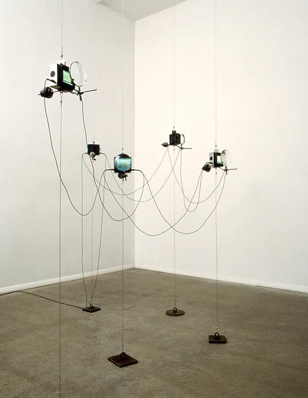 five video objects suspended in space by thin steel cables