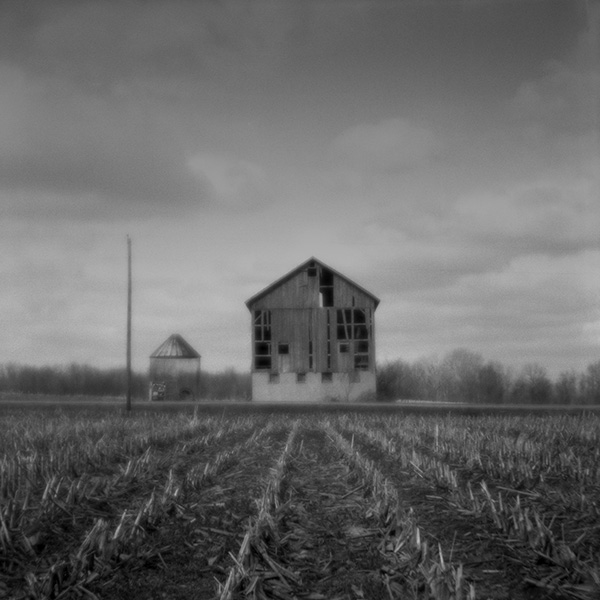 black and white photo of a barn