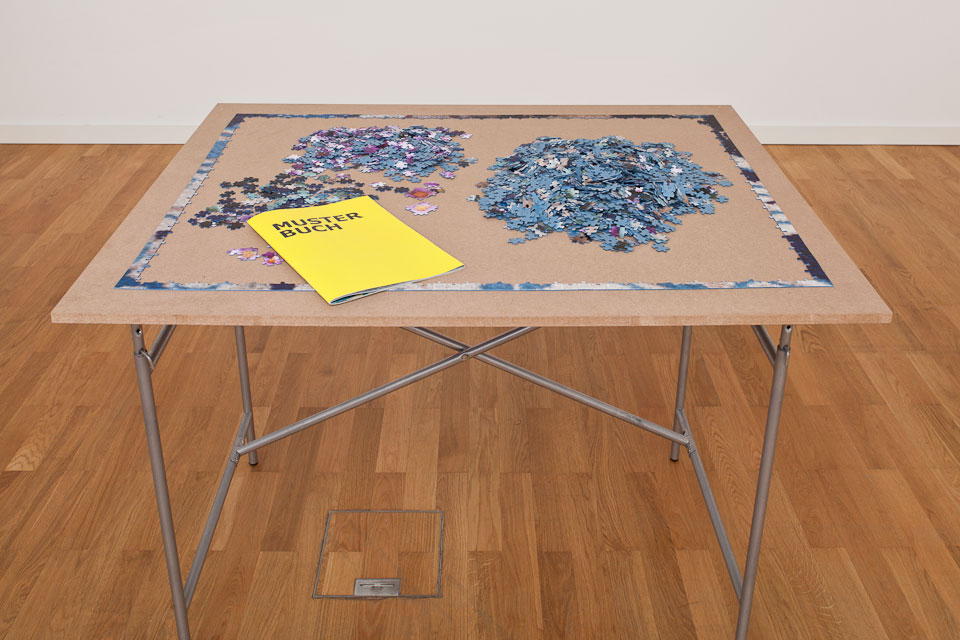 table with puzzle pieces, exhibition set up