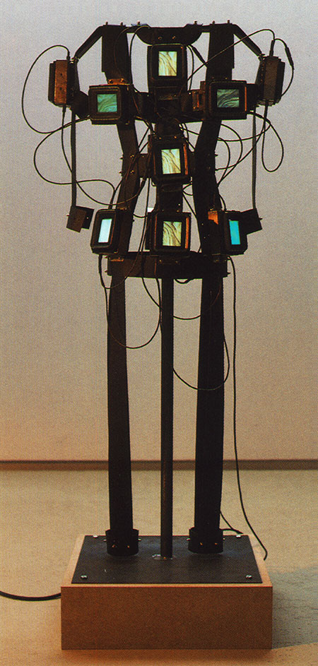video sculpture consisting of a rubber corsage and monitors shaping a human body