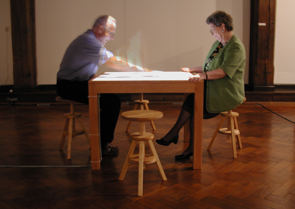 two people play slice_game inside the exhibition space